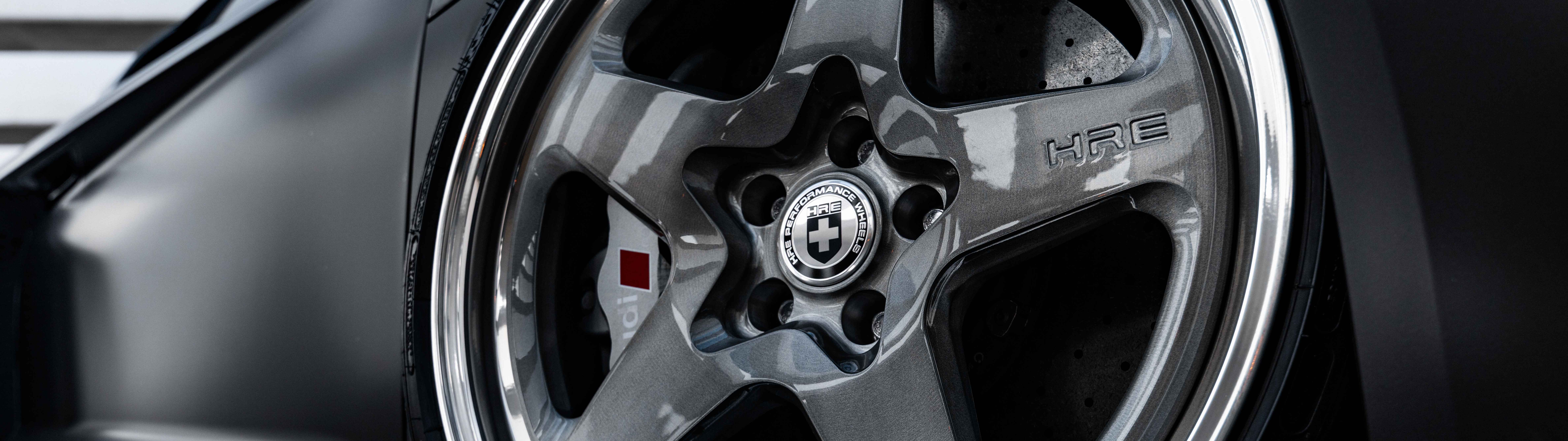 Ein professionelles Detailfoto einer eleganten Audi-Luxuslimousine mit einer glänzenden, metallisch lackierten Oberfläche.