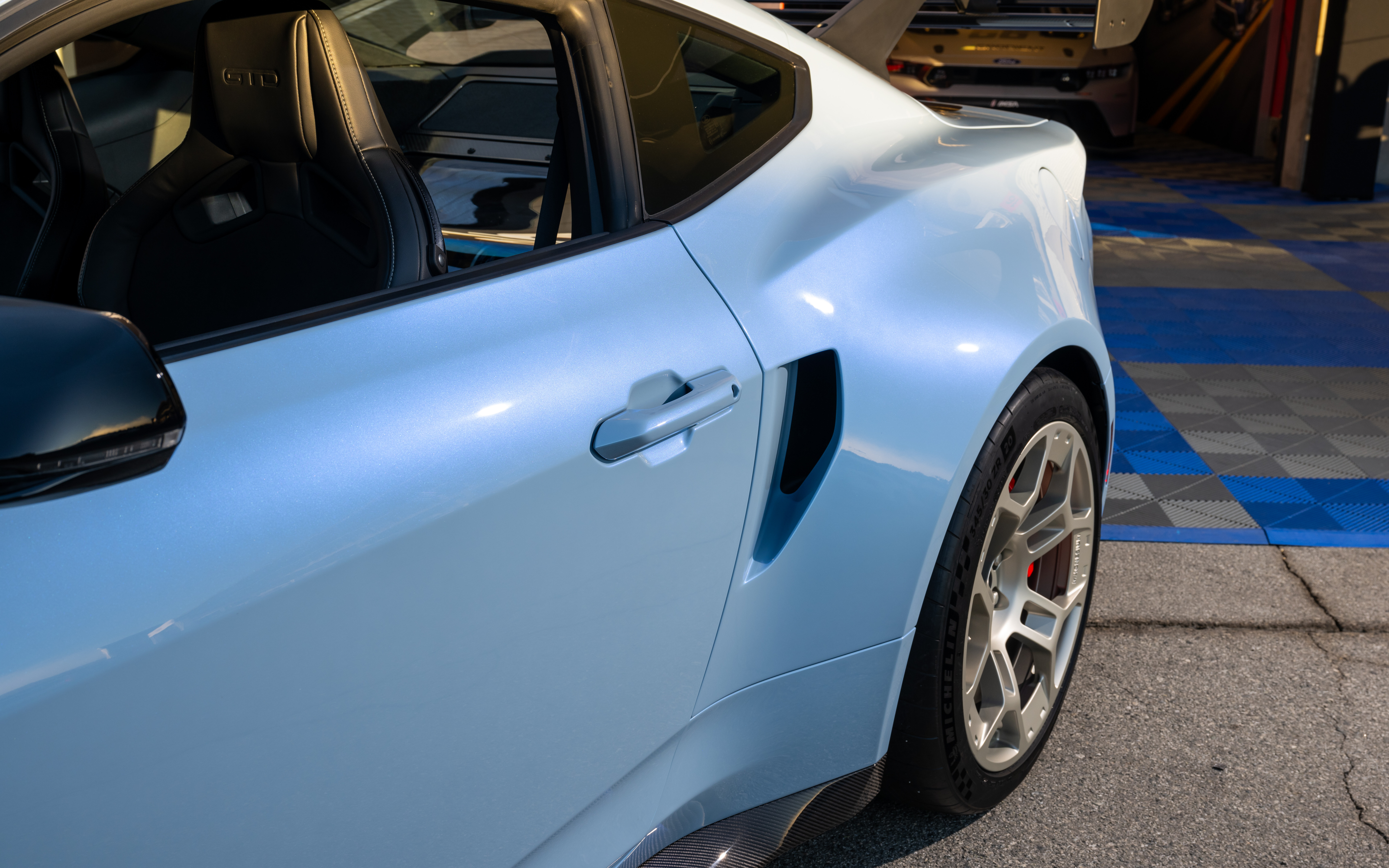 Eine detaillierte Ansicht eines Ford Mustang GTD, die sein auffälliges, auf Aerodynamik ausgelegtes Design und die verbreiterte Karosserie zeigt.